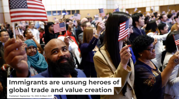 Carmindo Alves Barbosa Amado, originally of Cape Verde, waves the American flag after being sworn in during a naturalization ceremony in Boston in April 2024. Danielle Parhizkaran/The Boston Globe via Getty Images